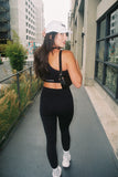 ULTIMATE COMPRESSION - ONYX RIBBED ZIP FRONT CROP TOP